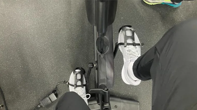 pro-form-studio-bike-pro-22-feet-in-toe-cages BarBend reviews writer Matt Cummings’ feet on the pedals of the ProForm Studio Bike Pro 22.