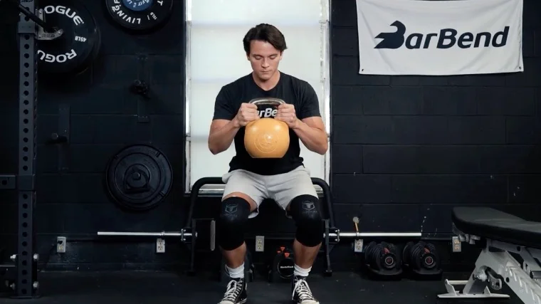 Our tester squats with a kettlebell while wearing Iron Bull Knee Sleeves on his knees.