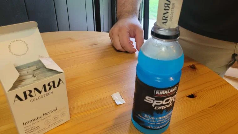 Our tester adding a packet of ARMRA Colostrum to their morning sports drink