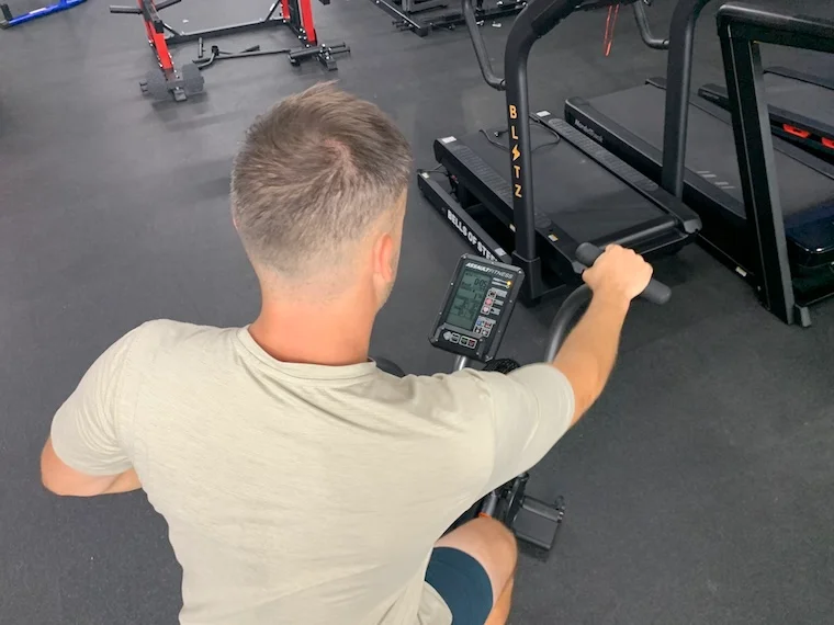 a person using the Assault Fitness AirBike Elite.