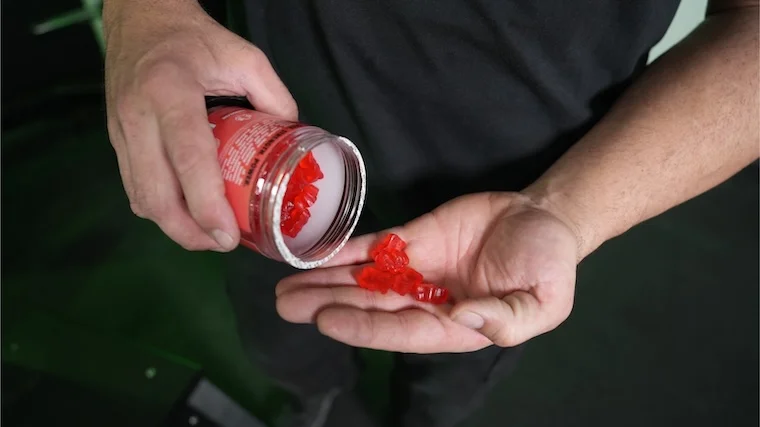 Our tester pouring a serving of Swoly Creatine Gummies