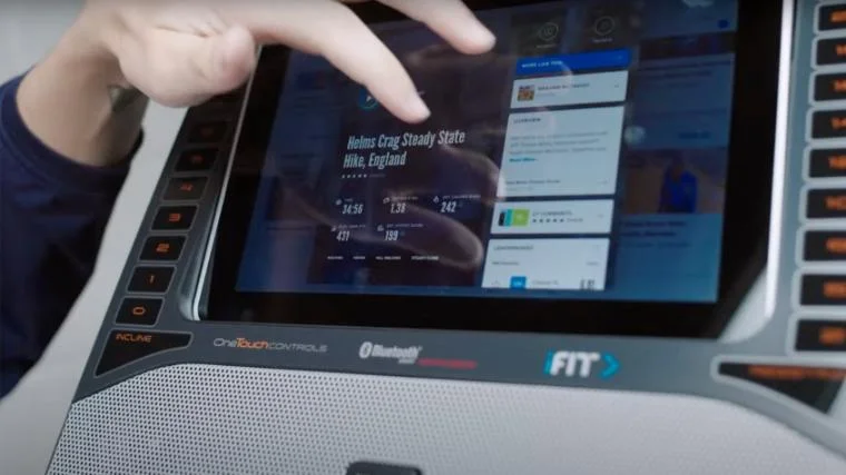 BarBend lead video reviewer Jake Herod selecting an iFIT class on the NordicTrack FS10i.