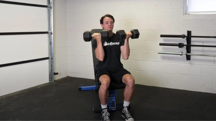 A person doing the Arnold press.