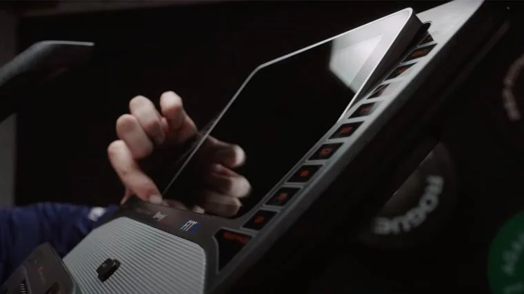 BarBend lead video reviewer Jake Herod tilting the screen on the NordicTrack FS10i.