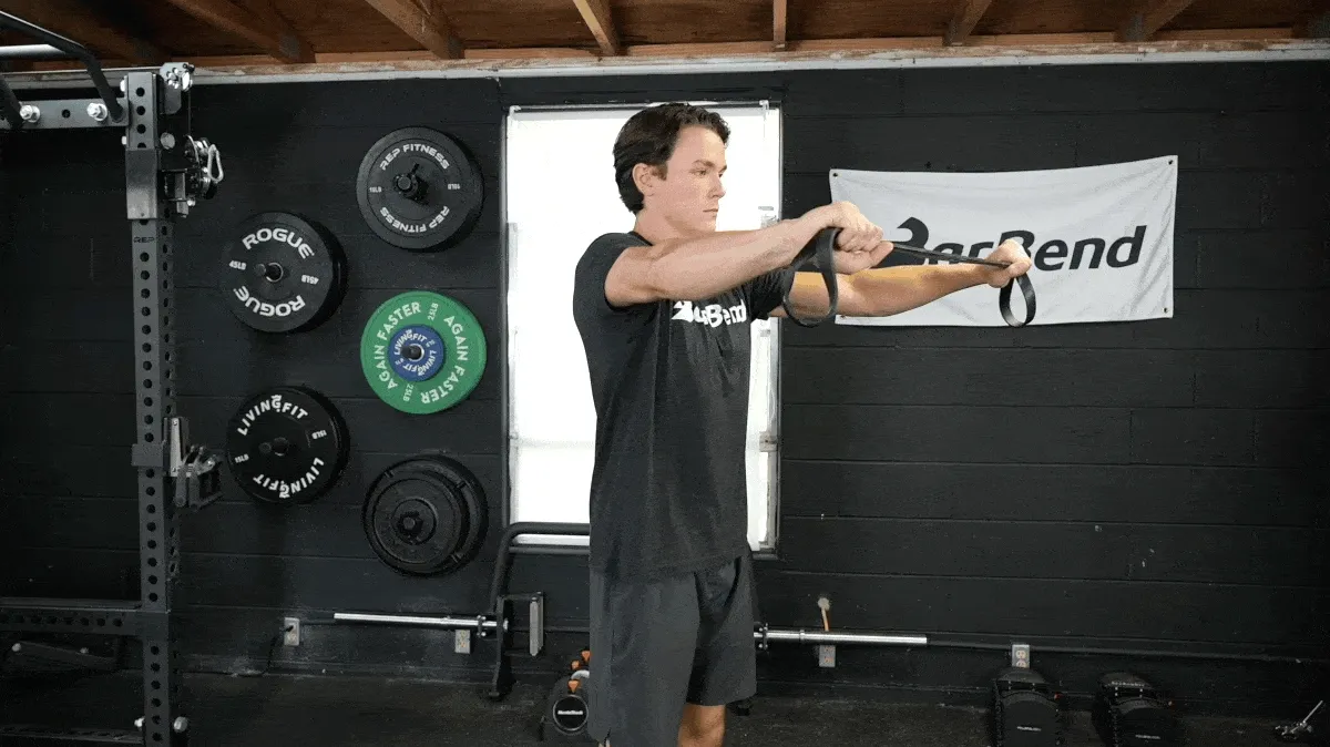 A person performing the band pull-apart exercise.