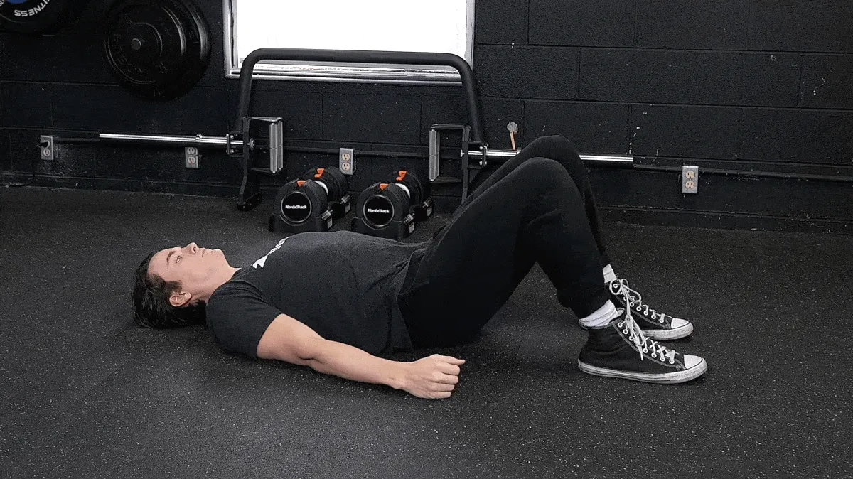 Jake performing the glute bridge exercise.