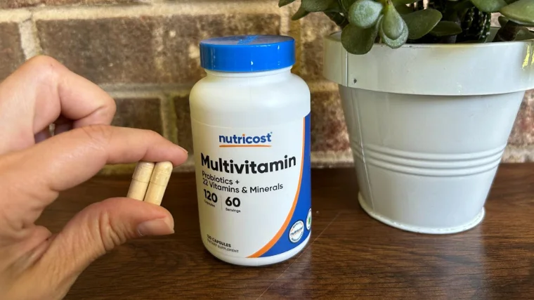 Two Nutricost Multivitamin capsules with the bottle.