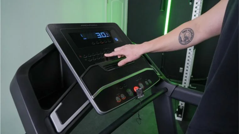 A person can be seen adjusting the controls on the ProForm Carbon TLX.