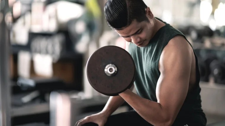 A person doing long head biceps exercises with a dumbbell.