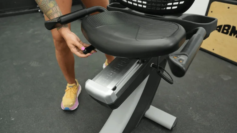 Our tester adjusting the seat on the NordicTrack Commercial r35 recumbent bike
