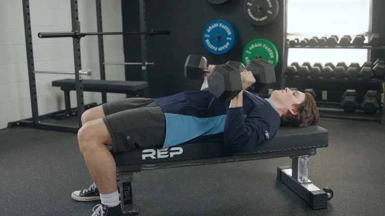Our tester using the REP Fitness FB-5000 for dumbbell bench presses.