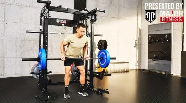 A man lifting weights in a Major Fitness home gym.
