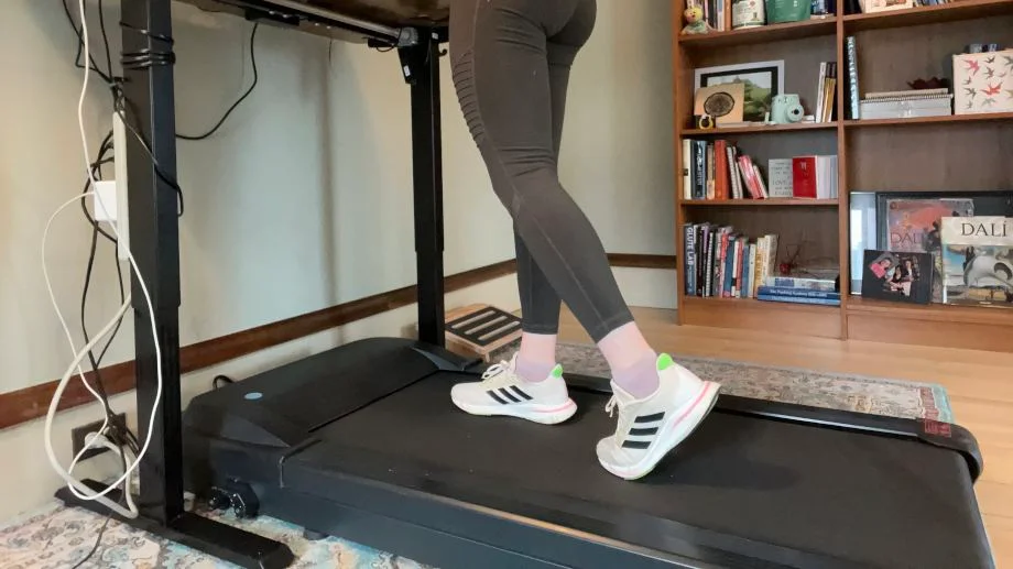 Close up view of a person walking on the Lifespan TR1000 Under Desk Treadmill.