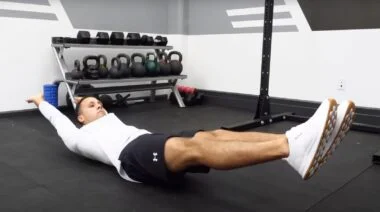 Barbend Featured Image A person doing the hollow holdexercise