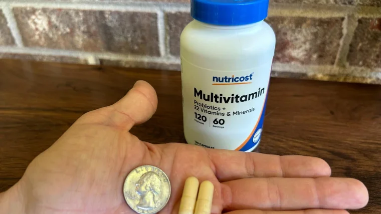 Comparing the size of a Nutricost Multivitamin to a quarter.