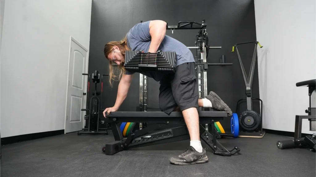 a person using the PowerBlock Adjustable Dumbbell