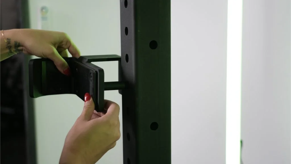 A person adjusting J-hook on Rogue Half Rack