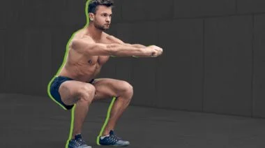 A person doing a standard squat as part of their best bodyweight exercises.