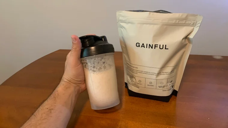 Our tester holds up a shake made with Gainful Protein Powder