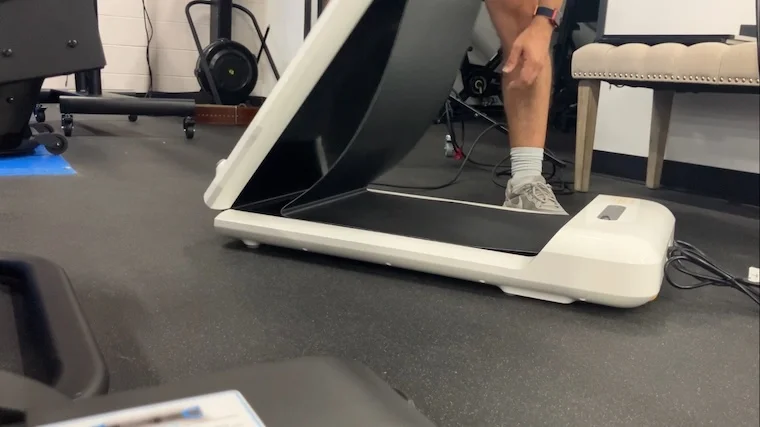 a person unfolding the WalkingPad C2 Mini Foldable Walking Treadmill.