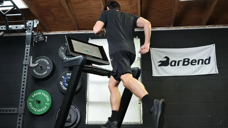 Jake running on a treadmill in the Barbend gym. 