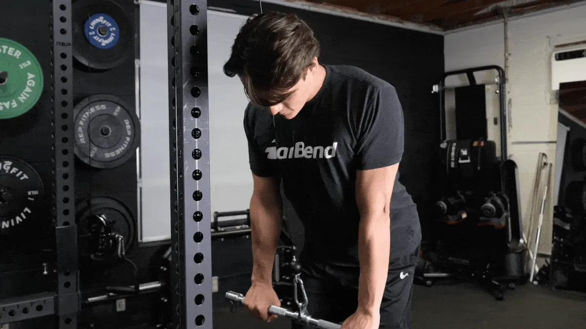 A person doing a cable pushdown exercise.