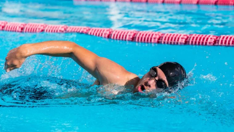 A person swimming in a pool.