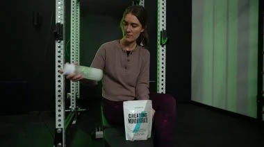 A BarBend tester is mixing MyProtein creatine in a shaker bottle.