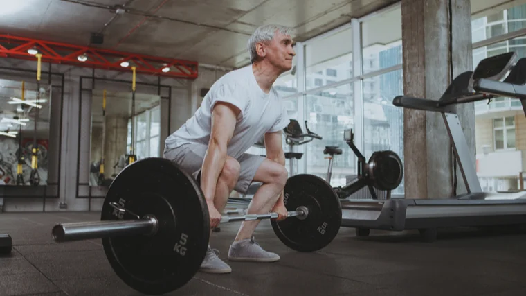 elderly man deadlifting