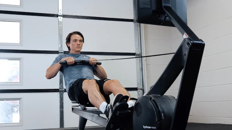 Our tester using the Hydrow Wave Rower.