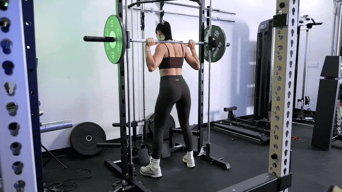Barbend's Bojana Gilic performing the back squat with a Smith machine.